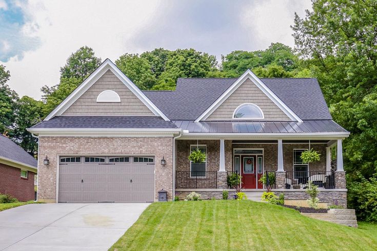 a large house with two garages in the front yard