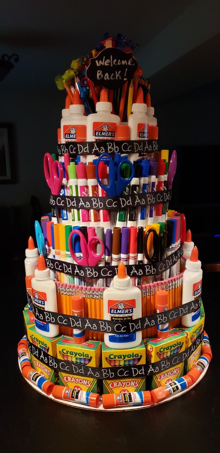 there is a cake made out of crayons and markers