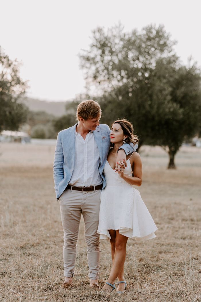 a man and woman standing in the middle of a field