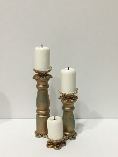 three white candles sitting next to each other