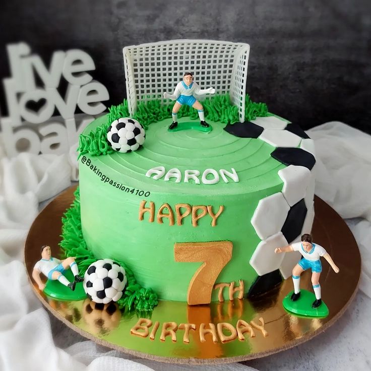 a soccer themed birthday cake with the number seven and two men playing soccer on it