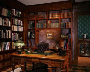 an old fashioned wooden desk in front of a bookcase filled with lots of books