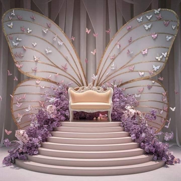 a white chair sitting on top of a set of stairs next to a giant butterfly