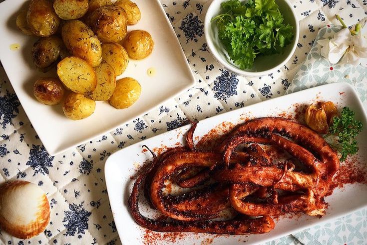 there are two plates with food on the table next to each other, including potatoes and shrimp