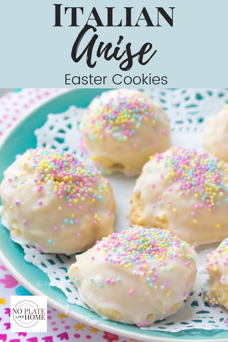 white chocolate covered cookies with sprinkles on a blue plate and pink and white polka dot tablecloth