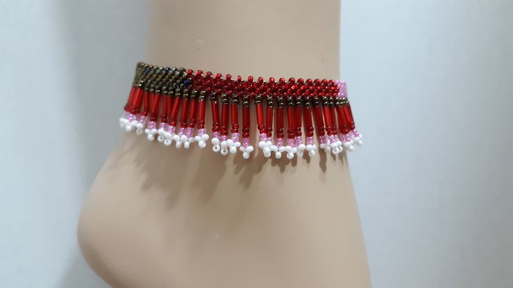 Handmade Boho Womens Girls Seed Bead Woven Geo Colorblock Adjustable Size Boho Fringed Anklet Native Tribal Red Jewelry Excellent Gift Beautiful handmade special fringed stitch....very complicated and GORGEOUS! Seed beads in red pinks white silver. Fringed anklet is adjustable with handmade bead ball and 3 loops 9 to 10 inches. Super high quality. Treasured gift comes in box. Easy to wear casual chic vintage for the disco sporting life. **Please note the color differences, color/contrast vary wi Handmade Red Choker For Beach, Multicolor Beaded Anklets For Party, Beach Red Beaded Choker, Adjustable Red Anklets With Round Beads, Adjustable Red Anklet Bracelet, Festive Red Handmade Choker, Adjustable Red Anklets For Festivals, Red Beaded Anklets For The Beach, Handmade Red Beaded Bracelets For Party