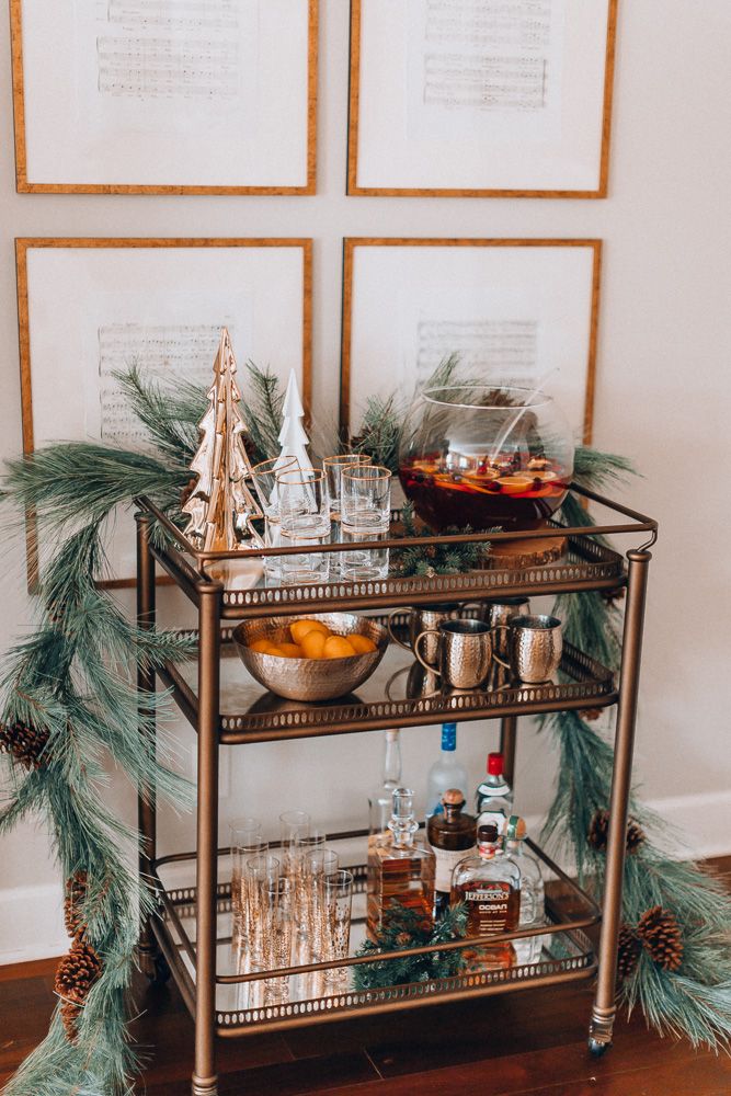 the bar cart is decorated with pine branches