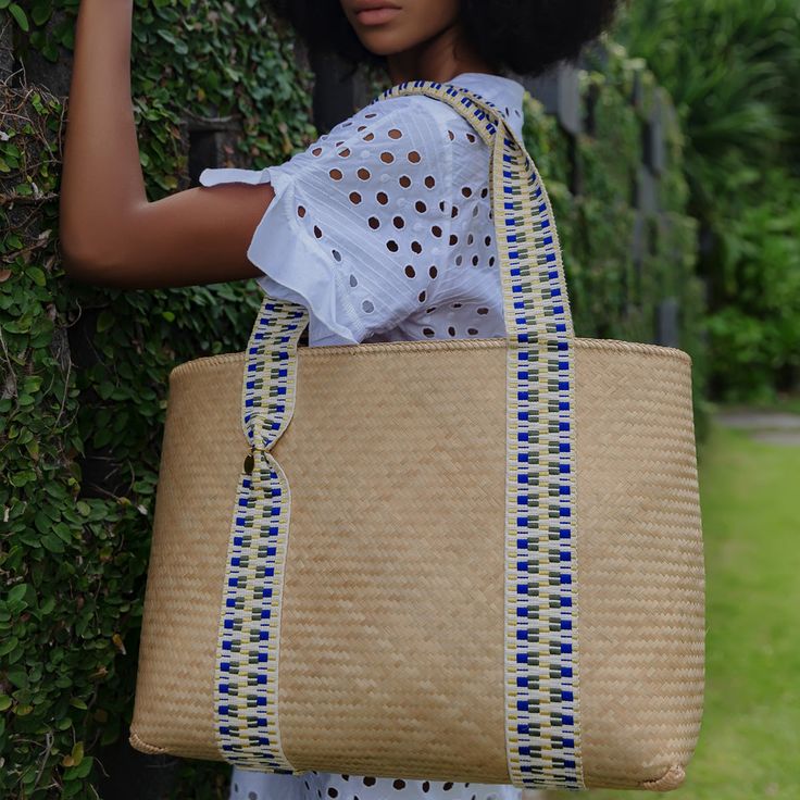 This vegan bamboo tote bag is a contemporary take on a summer favourite. Robust and lightweight in equal measure, it is handcrafted using traditional Lombokian weaving skills, offset with contemporary jacquard straps. Sling the bag over your shoulder for trips to the market and beach alike. This tote bag also comes with its own unique code, that connects you to the artisan who handcrafted it for you. Please note that Archive Sale purchases are final sale. We are unable to accept returns. Traditional Tote Beach Bag For Travel, Handwoven Double Handle Shoulder Bag For Vacation, Vacation Handwoven Shoulder Bag With Double Handle, Traditional Travel Bags For Summer, Traditional Summer Travel Bags, Traditional Tote Bag With Bamboo Handle, Traditional Bag With Bamboo Handle For Everyday Use, Traditional Bags With Bamboo Handle For Everyday Use, Eco-friendly Shoulder Bag With Bamboo Handle For Daily Use