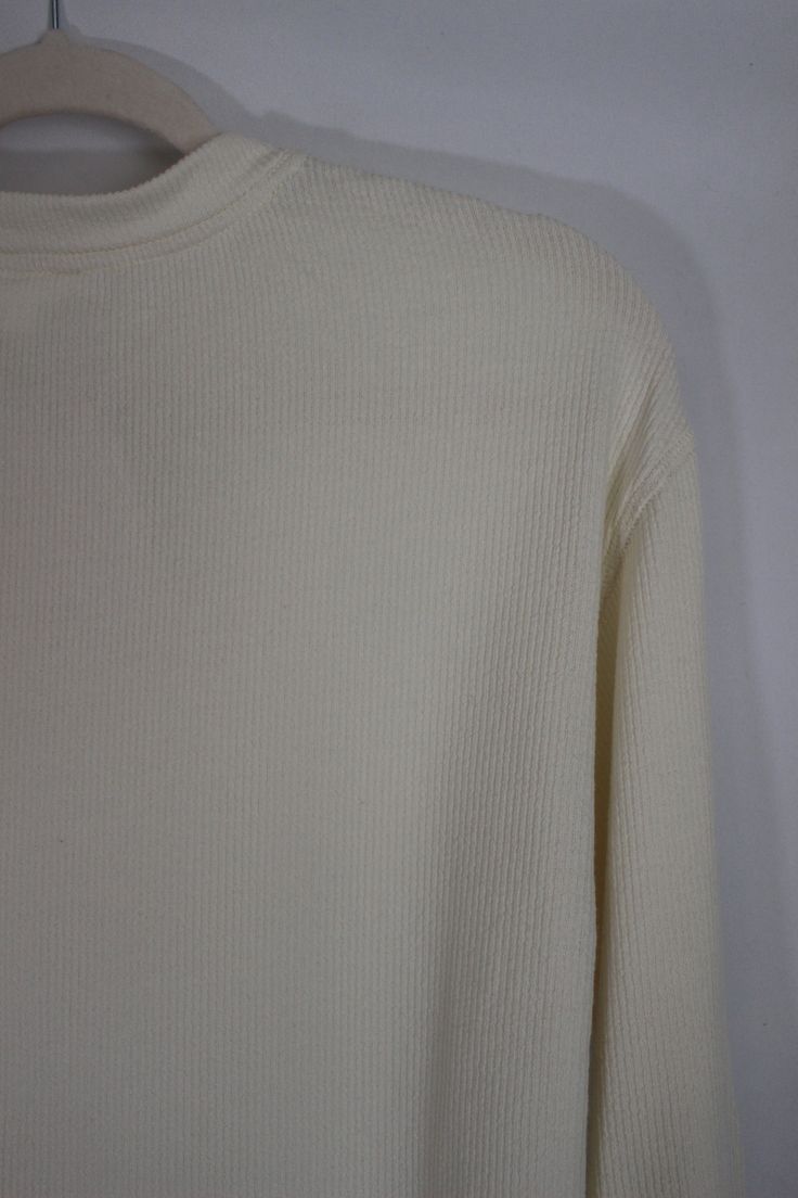 Everyday and simple cream ribbed knit top with long sleeves, cropped fit, and front pocket details details & fit: fits true to size. 64% cotton, 30% polyester, 6% spandex measurements: small: bust 36"/ waist 36"/ length 17.5" medium: bust 38"/ waist 38"/ length 18" large: bust 40"/ waist 40"/ length 18.5" model details: model is 5'7" and wearing size small Winter Cotton Ribbed Long Sleeve Top, Winter Ribbed Cotton Long Sleeve Top, White Long Sleeve Cropped Sweater With Ribbed Collar, White Long Sleeve Sweater With Ribbed Neckline, White Cropped Long Sleeve Sweater With Ribbed Collar, White Cropped Sweater With Ribbed Collar, Fitted White Cropped Sweater With Ribbed Cuffs, White Cropped Sweater With Ribbed Collar And Long Sleeves, White Stretch Long Sleeve Cropped Sweater