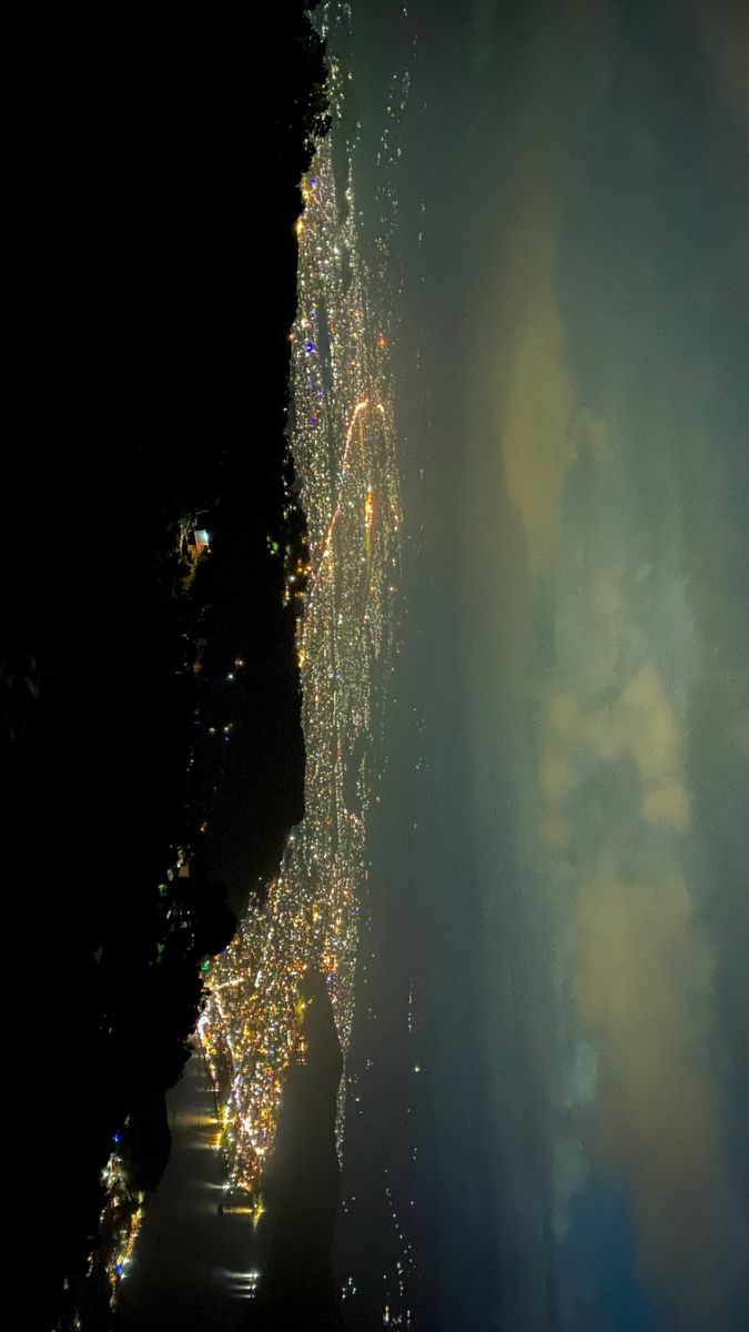 an aerial view of the city lights at night from space, looking down on it