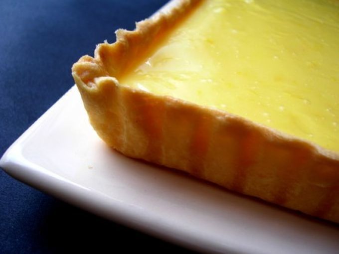 a piece of cheese pie on a white plate