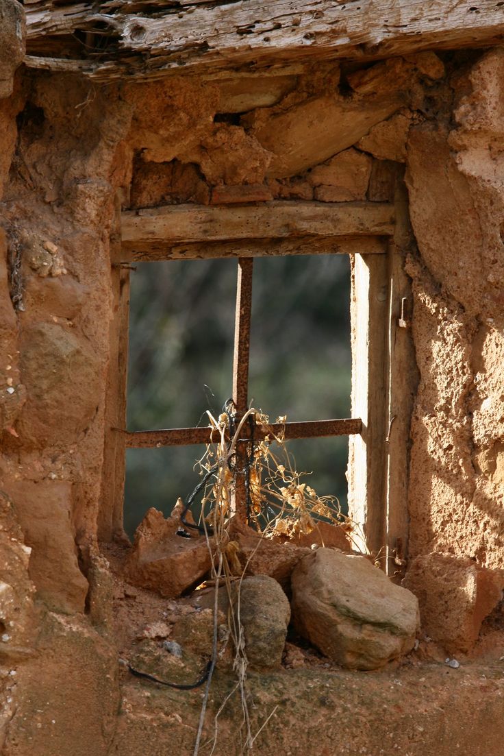 an old window in the side of a stone building