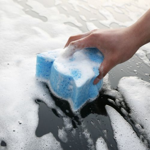 someone is cleaning the snow with a blue and white block of soap on top of it