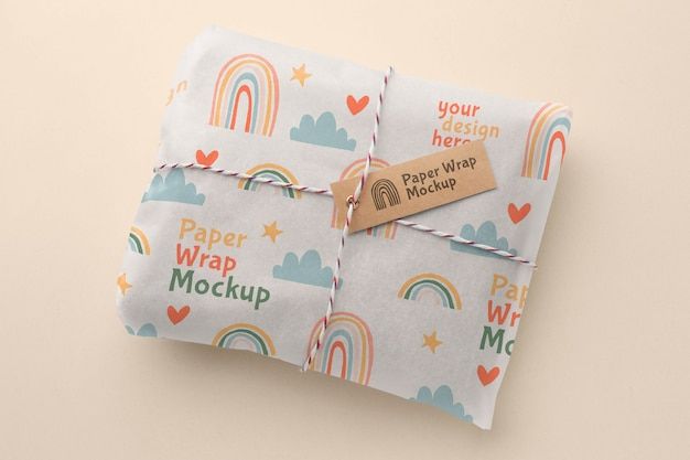 a package wrapped in white paper with rainbows and clouds on it