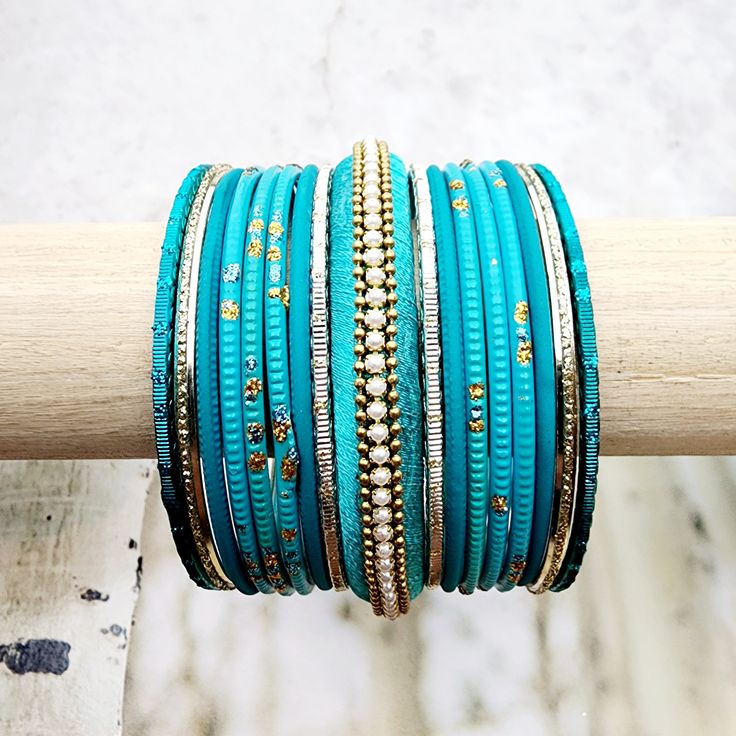 Beautifully designed bangles for any occasion. South asian bracelets come in a variety of styles, colors, and finishes. We at Banglez take creating the perfect bangle set for you to another level! You could say helping you find your favorite stack of bangles as one of our greatest missions. This bangle set was curated in house by one of our talented team members. We hope you love them as much as we do! Traditional Stackable Bangle Bracelets, Stackable Bangle Bracelets For Festivals, Traditional Adjustable Stackable Bracelets, Stackable Bracelets For Festivals, Gold Bangle Wrap Bracelet For Festival, Bohemian Stackable Wedding Bracelets, Elegant Turquoise Bangle For Wedding, Festive Stackable Bracelets For Festivals, Turquoise Bangle Bracelets For Wedding