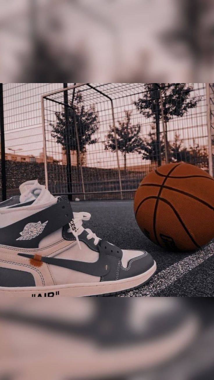 a pair of sneakers sitting next to a basketball