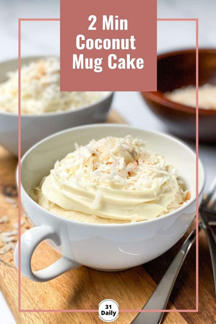 two white bowls filled with cake on top of a wooden cutting board next to silverware