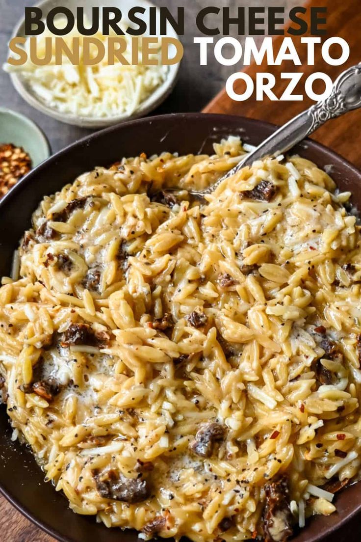 a bowl filled with pasta and cheese on top of a wooden table