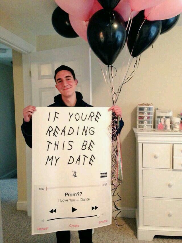 a man holding up a sign that says if your reading this be my date