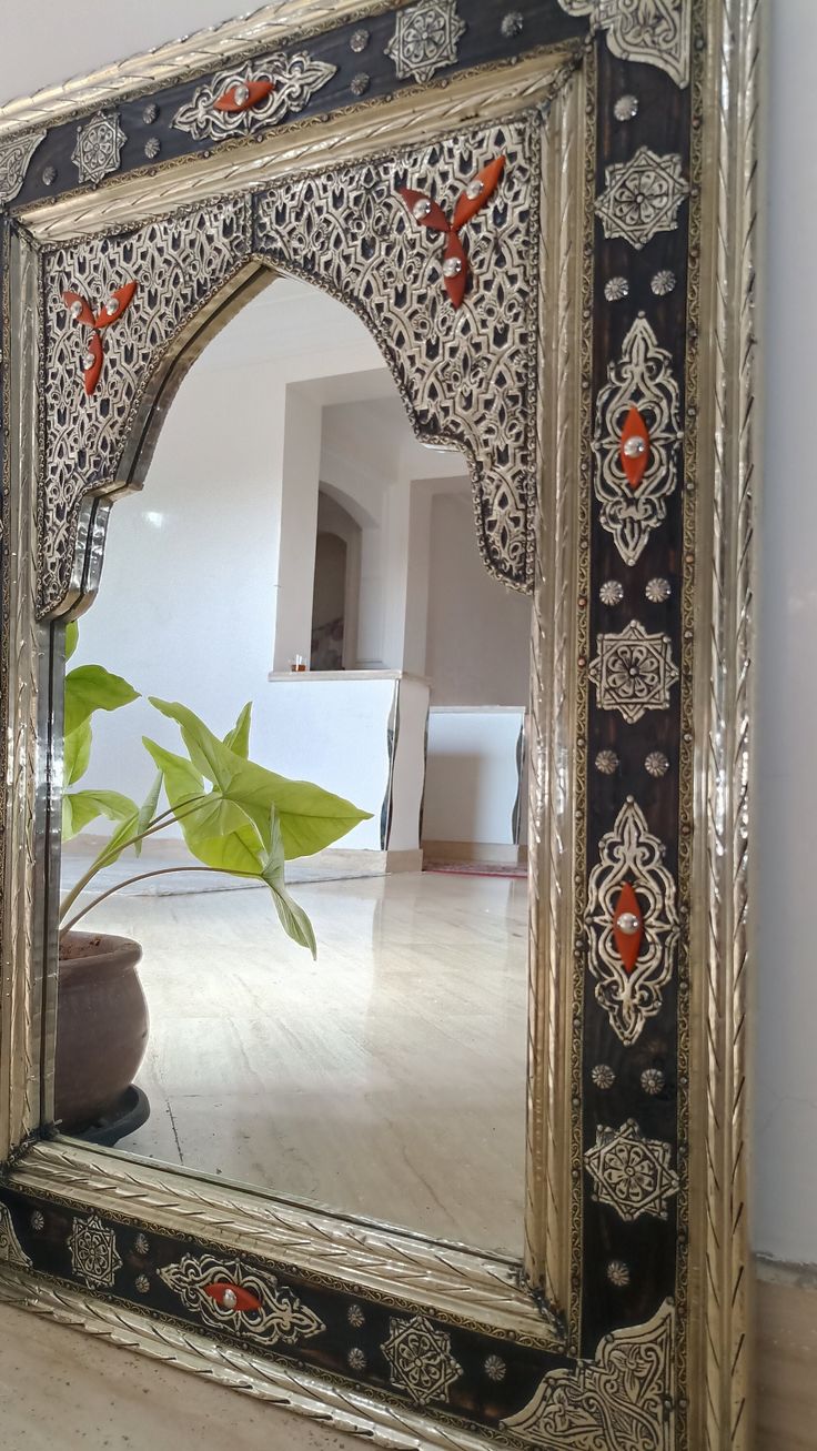 an ornately decorated mirror on the wall