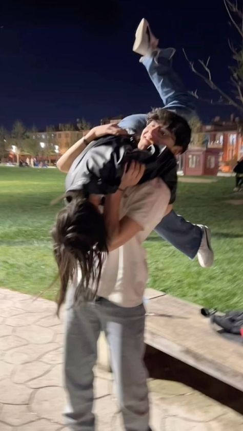 two people are doing tricks on a skateboard