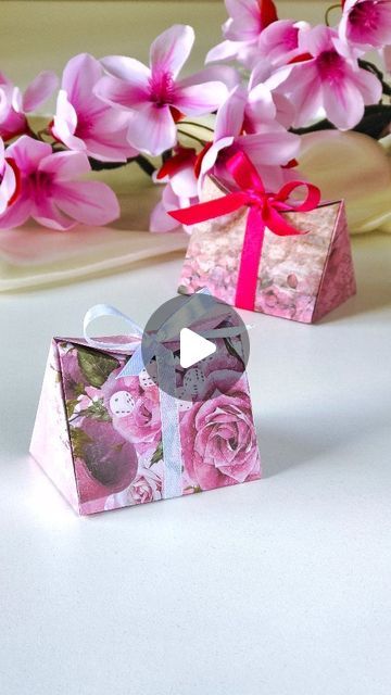 two small boxes with pink flowers in them