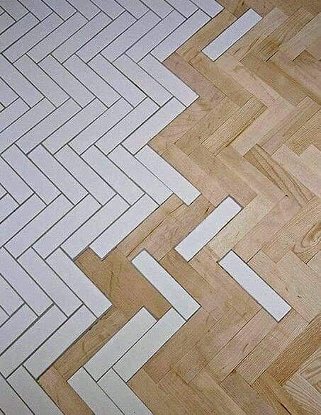 the floor is made out of wood and has white tiles on it, as well as an arrow pattern