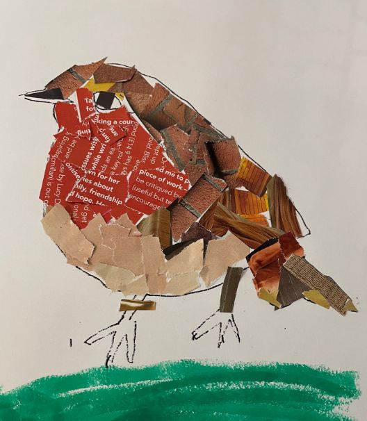 a bird made out of pieces of paper with words written on the wings and feet