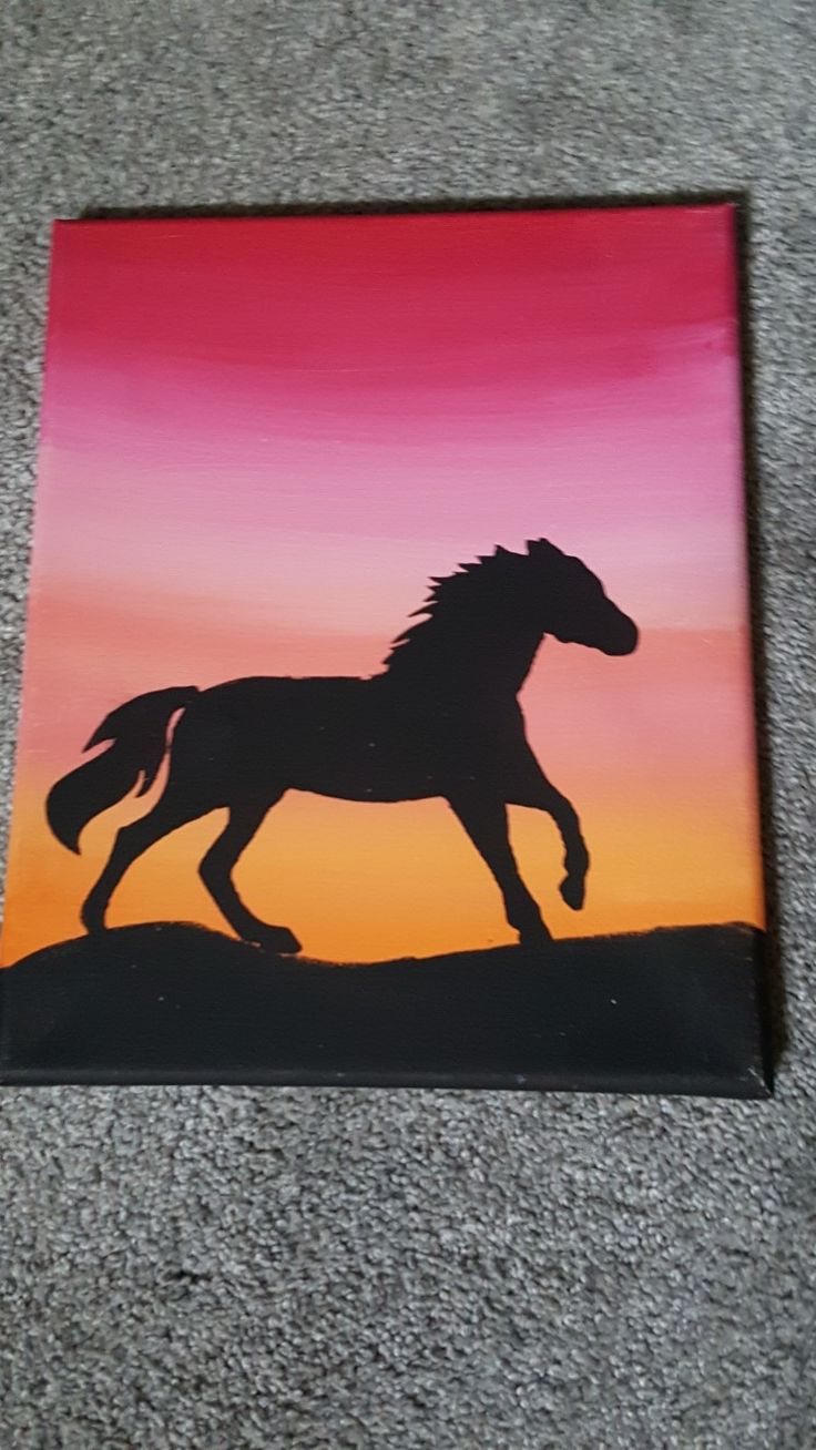 a painting of a horse running in the sunset on a tile floor with grey carpeting