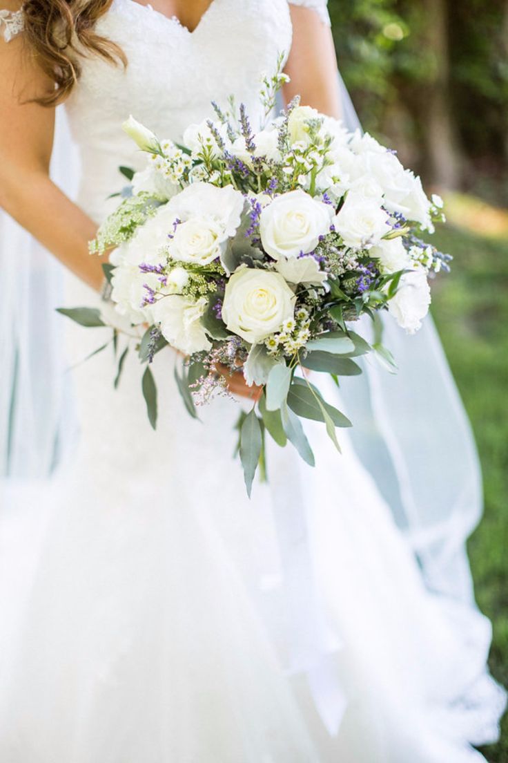 a woman in a wedding dress holding a bouquet