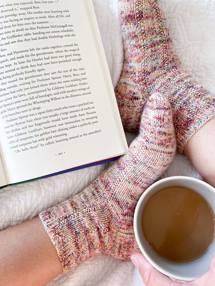 a person wearing socks and holding a cup of coffee