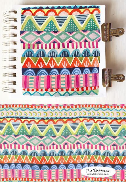 an open notebook with colorful designs on it