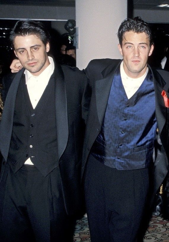 two men in tuxedos standing next to each other