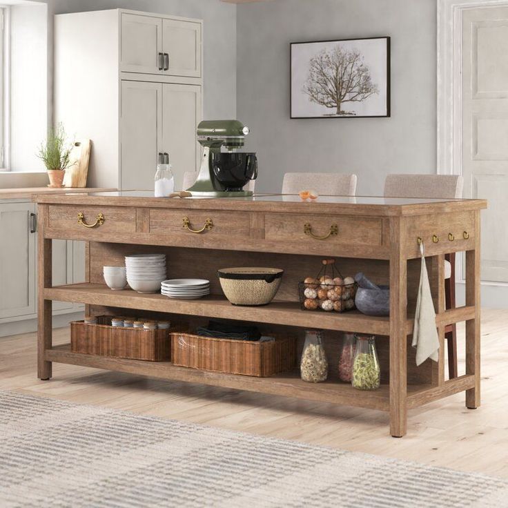 a kitchen island with baskets and bowls on it in the middle of a living room