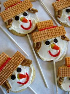 some waffles with frosting on them are decorated like a snowman and wearing a hat