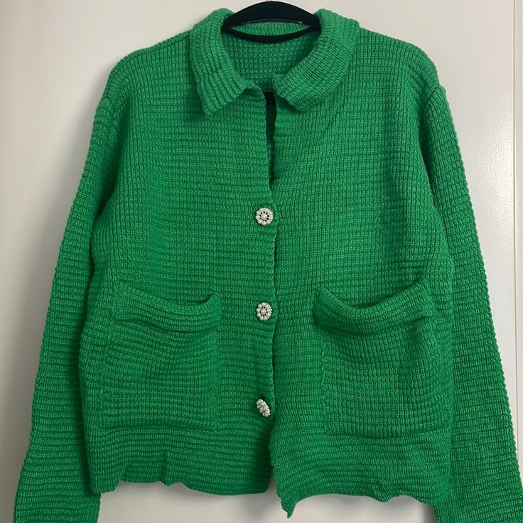 Green Knitted Cardigan. Pearl Flower Buttons. Front Pockets. Collar Green Knit Button-up Outerwear, Trendy Green Knit Sweater Coat, Green Button-up Knit Outerwear, Green Soft Knit Sweater Coat, Spring Green Soft Knit Sweater Coat, Green Textured Knit Long Sleeve Cardigan, Spring Button-up Open Knit Sweater, Spring Knit Button-up Outerwear, Green Soft Knit Outerwear