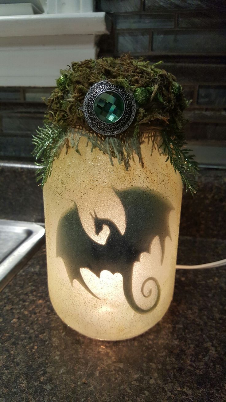 a glass jar with moss growing out of it