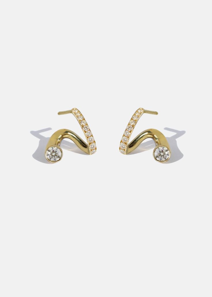 —The Crescendo Collection Crafted in polished 18K gold, the Peak Earring is a contemporary take on an everyday earring that elegantly flows around the ear. This earring combines a classic pavé huggie hoop with the illusion of a floating diamond stud that nestles underneath the ear. This earring is designed to be worn on a specific side, choose either Right or Left before adding to cart. Sold as singles. Diamond Grade: F/G color, VS clarity 0.27ct — 0.5" in length Available in Yellow Gold, White Pave Ear Cuff, Diamond Ear Cuff, Double Earrings, Light Jewelry, Jewellery Design Sketches, Engagement Earrings, 18k Gold Earrings, Jewelry Ads, Diamond Jewelry Designs