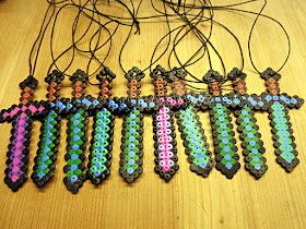 several pieces of bead art on a wooden table