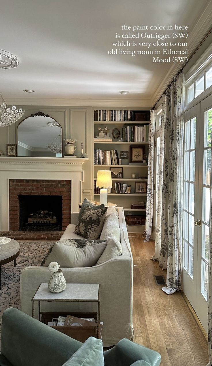 a living room filled with furniture and a fire place in front of a book shelf