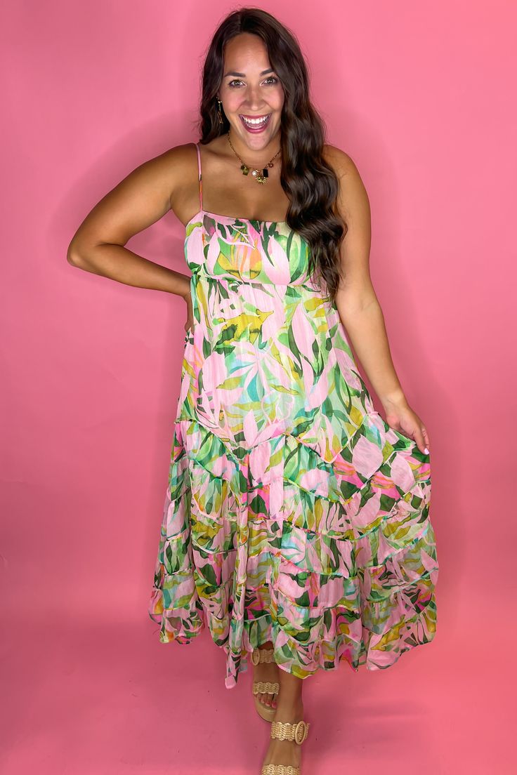 Gorgeous tropical maxi dress with a sparkle metallic look to it! Zipper in the back Lined FIT: True to size but no stretch! So size up if in between sizes. Model is a size 8, 36DD wearing a large. 100% Polyester Pink Tropical Print Maxi Dress, Tropical Maxi Dress For Party, Tropical Maxi Party Dress, Tropical Style Maxi Party Dress, Spring Tropical Maxi Dress For Party, Chic Tropical Print Maxi Dress For Summer Parties, Tropical Style Maxi Dress For Summer Parties, Casual Tropical Print Maxi Dress For Party, Green Tropical Maxi Dress For Party