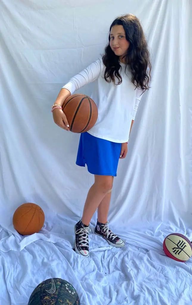 Looking for a school skirt that is uniform approved, looks cute during class and then works great for basketball practice? Look no further than the Tween All Day Active Skirt! It's a perfect uniform option with its school colors. The active skirt’s luxurious comfort is thanks to a blend of sweat-wicking fabric that allows you to move about freely. The fabric stands up to the physical activity and keeps your kid comfortable all day long. Ethically and Sustainably Made in Los Angeles To learn more Sporty Mini Tennis Skirt For School, Casual Solid Color Cheerleading Skirt, Casual Cotton Tennis Skirt For Cheerleading, Casual Cotton Cheerleading Skirt, Casual Cotton Skirt For Cheerleading, Casual Cotton Skort For Cheerleading, Fabric Stands, Basketball Practice, School Skirt