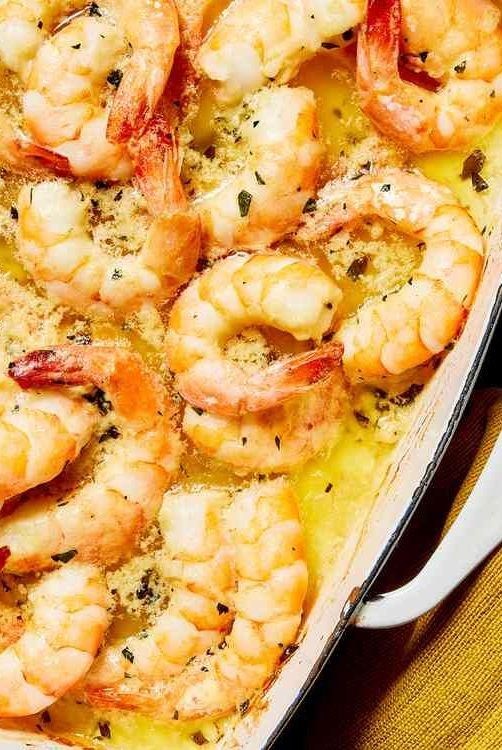 a casserole dish filled with shrimp and cheese