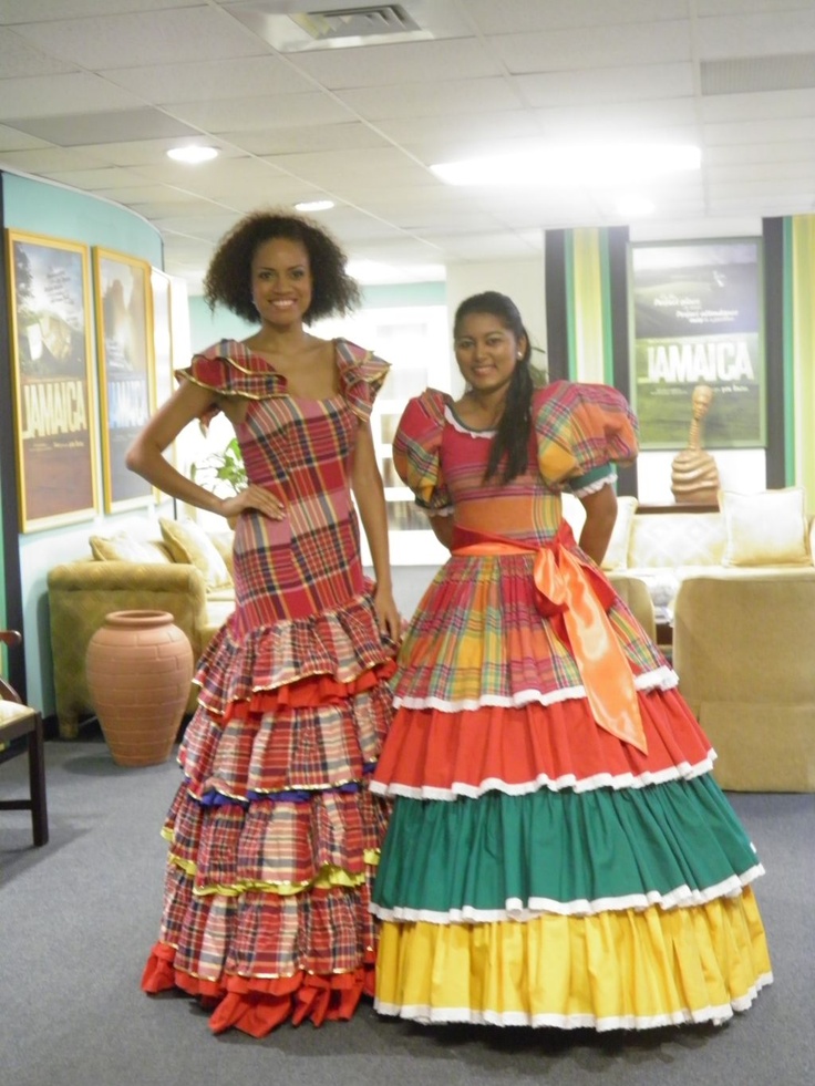 two women standing next to each other wearing dresses with ruffles on the skirt