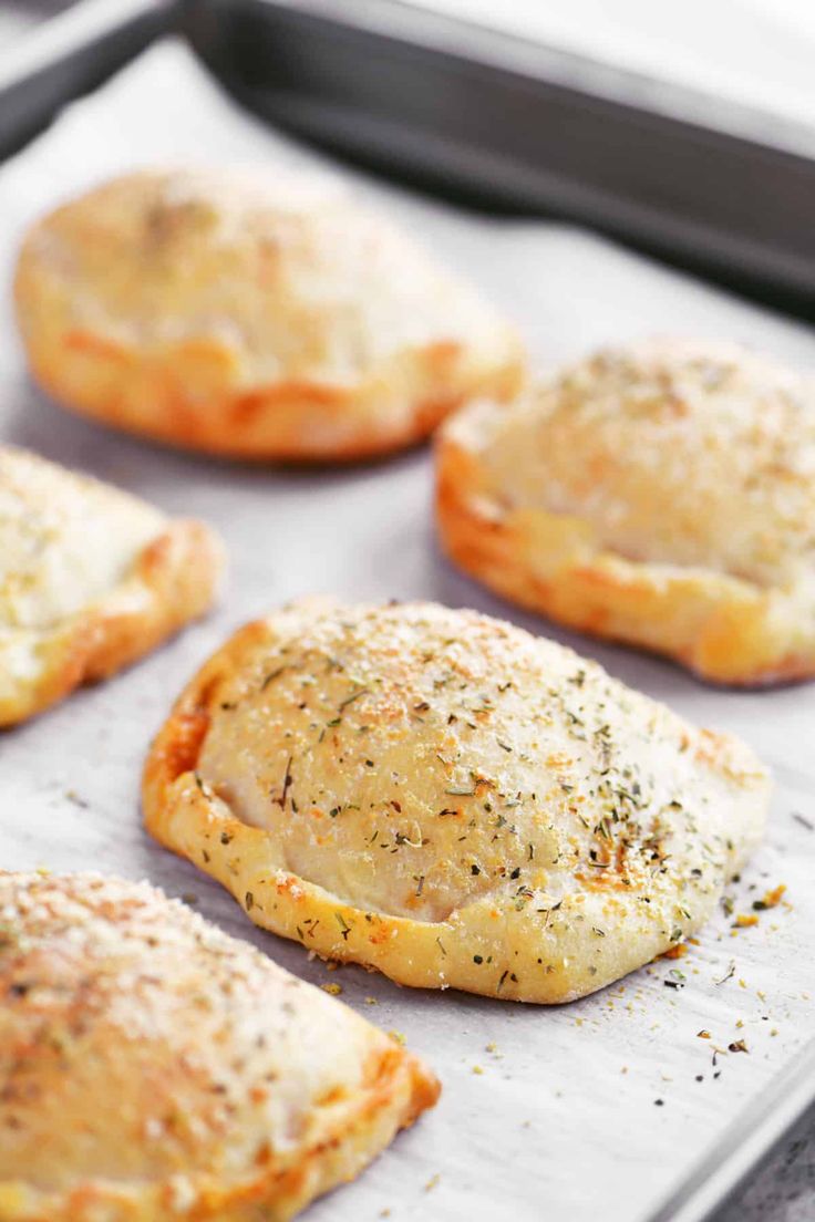 baked pastries sitting on top of a baking sheet