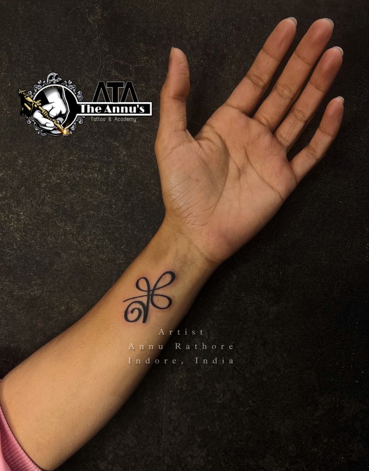 a person's hand with a tattoo on it