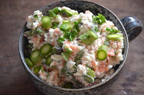 a bowl filled with cucumbers, celery and tuna salad on top of a wooden table