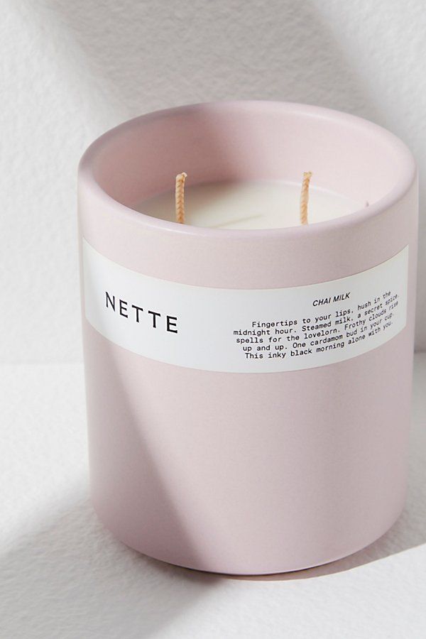 a pink candle sitting on top of a white table