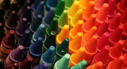 many different colored crayons are lined up in rows and stacked on top of each other