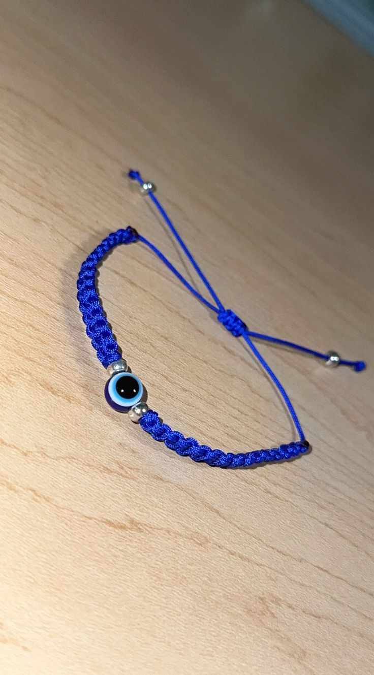 Handmade simple blue evil eye bracelet. Adjustable Blue Friendship Bracelets With Evil Eye, Casual Blue Friendship Bracelets With Evil Eye, Adjustable Round Evil Eye Bracelet, Blue Adjustable Evil Eye Bracelet, Adjustable Blue Evil Eye Bracelet, Adjustable Blue Evil Eye Bracelet For Spiritual Purposes, Adjustable Blue Spiritual Evil Eye Bracelet, Blue Beaded Bracelets With Evil Eye, Handmade Blue Evil Eye Bracelet Casual Style